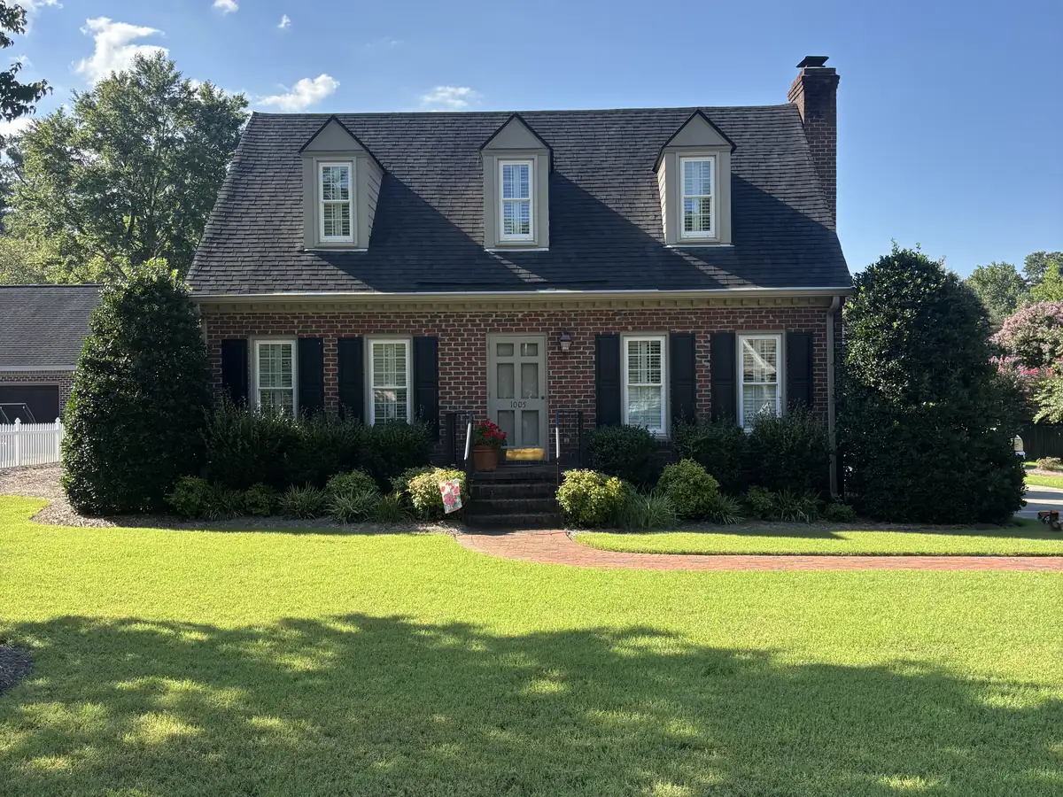 Home with full curb appeal and landscaped beds by Carolina Turf & Lawn